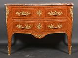 an antique chest of drawers with a marble top