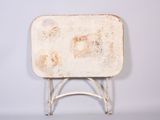 a small white table with a metal base on a white background