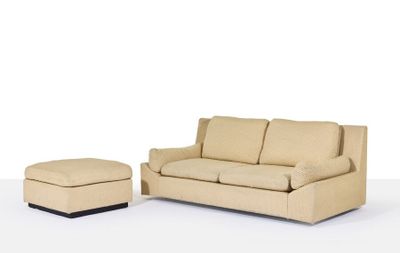 a couch and ottoman in a room with a white background