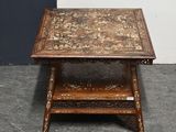 an old wooden table with a decorative design on top of it