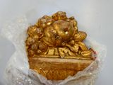 a gold statue of a pig on a table