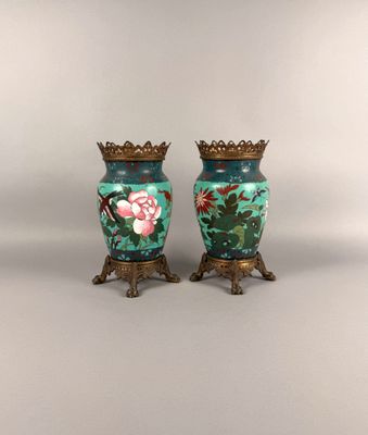 two vases that have been painted with flowers on them