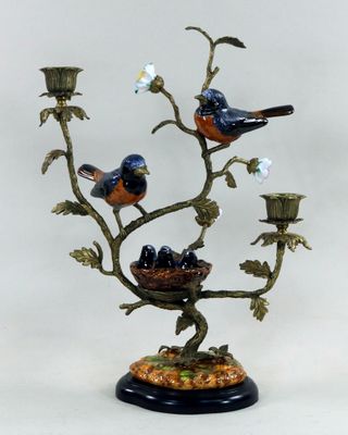 trois oiseaux perchés sur un arbre où se trouve un nid d'oiseau