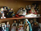 many dolls on the shelves in the room