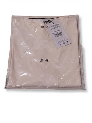 the white shirt is wrapped in plastic and has a tag on it