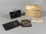 four purses and a handbag sitting on a table