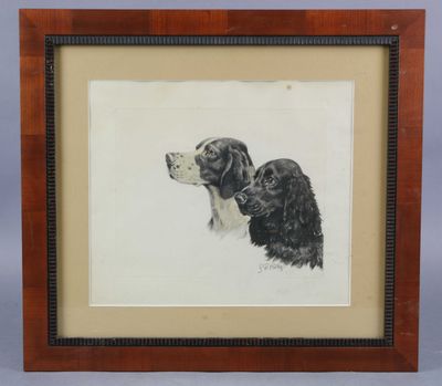 tableau représentant un chien et un chat, encadré et posé sur une table