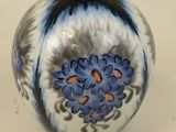 a blue and white vase sitting on a table