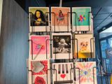 a display of cards on a rack in a room