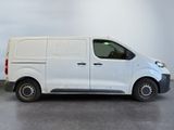 the white van is parked in a room with a gray floor