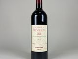 the bottle of red wine is sitting on the table