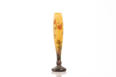 a glass vase with flowers on it on a white surface
