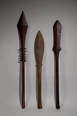 two wooden spoons and a fork are sitting on a table