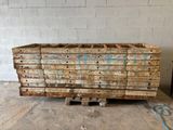 a pile of wood sitting on a pallet in a warehouse