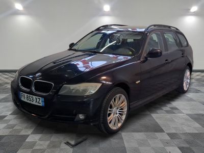 a picture of a black bmw wagon parked in a garage