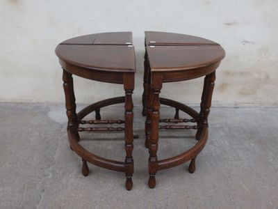 pair of antique wooden side tables with turned legs on concrete floor