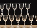 a lot of wine glasses that are sitting on a table