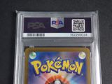 the pokemon card is in a clear plastic holder on a table