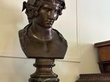 a bust of a woman sitting on top of a table