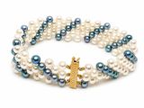 three strand bracelet with blue and white pearls and a gold anchor