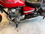 a red motorcycle that is parked in a garage