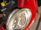 a close up of a red motorcycle with its hood open