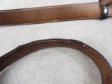 a brown belt with a black buckle on it