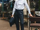 a man that is standing next to a bench
