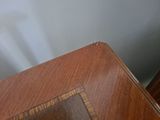 a cat that is sitting on top of a wooden table