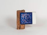 small blue and white square with red and white fish in it on a wooden stand