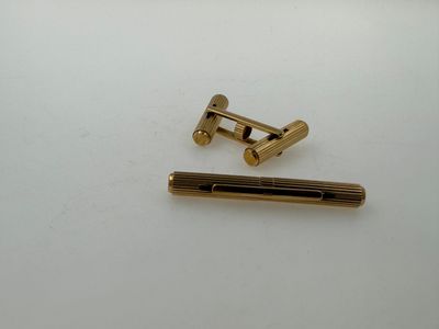 a close up of a pair of brass screws on a white surface