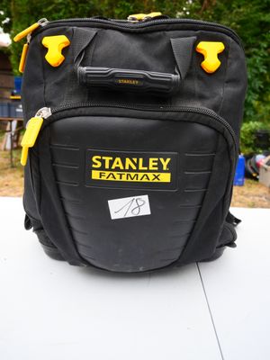 a black bag with yellow handles sitting on top of a table