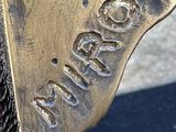 a close up of a bronze statue of a horse