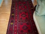 a red rug on the floor in a living room