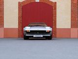 a silver car parked in front of a red garage door