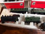 three toy trains sitting on a tray on a table