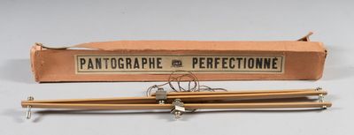 two knitting needles sitting next to a box on a table