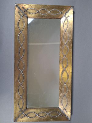 mirror with a gold frame and a decorative design