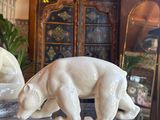 two statues of polar bears sitting on a glass table