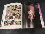 an open comic book with a picture of a woman in a pink dress