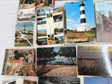 many different pictures of a lighthouse on a table