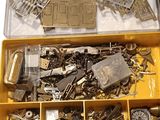 a yellow box filled with assorted metal parts