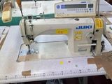 a sewing machine that is sitting on a table in a room