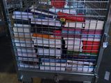 a cart full of books sitting on the floor
