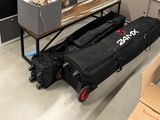 a black bag sitting on top of a cart in a room