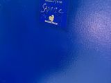 a close up of a blue plastic box with a sticker on it