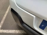 a white car parked in a parking lot with a european flag on it