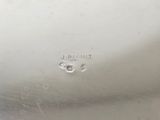 an image of a silver plate with a small hole in the middle of it