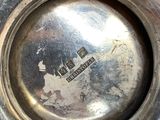a close up of a silver plate with a logo on it