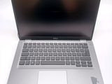 a silver laptop computer sitting on a white surface